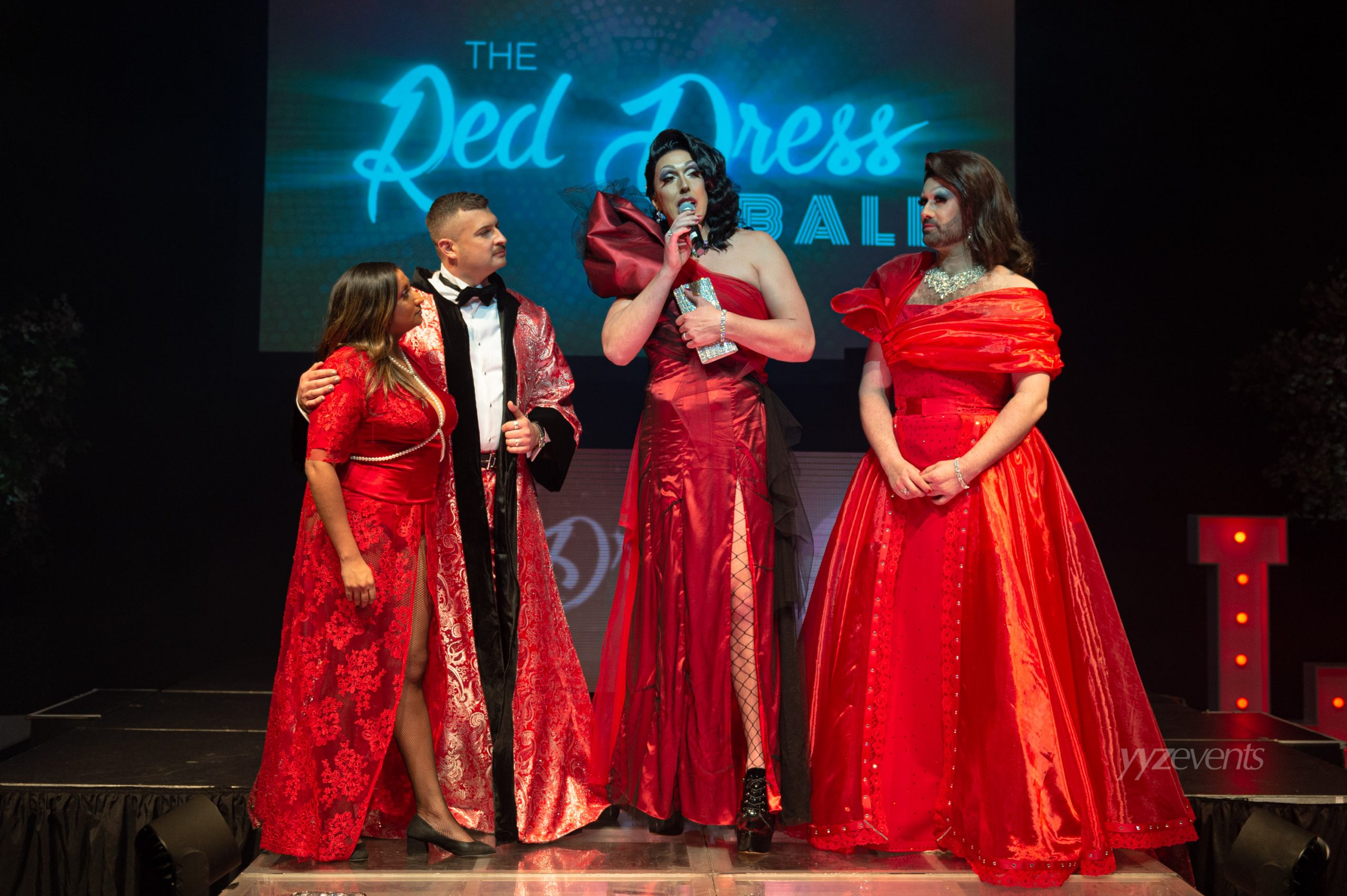 The founders of The Red Dress Ball on stage